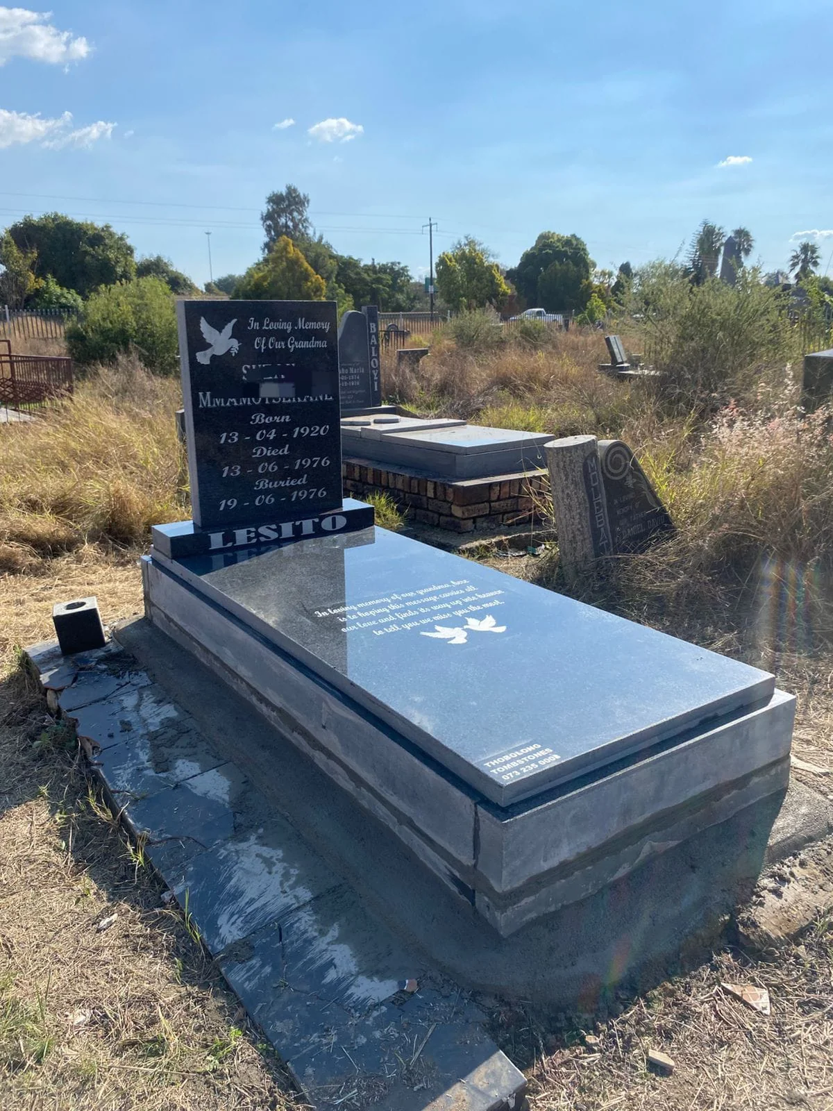 Polished black granite single tombstone in memorial park